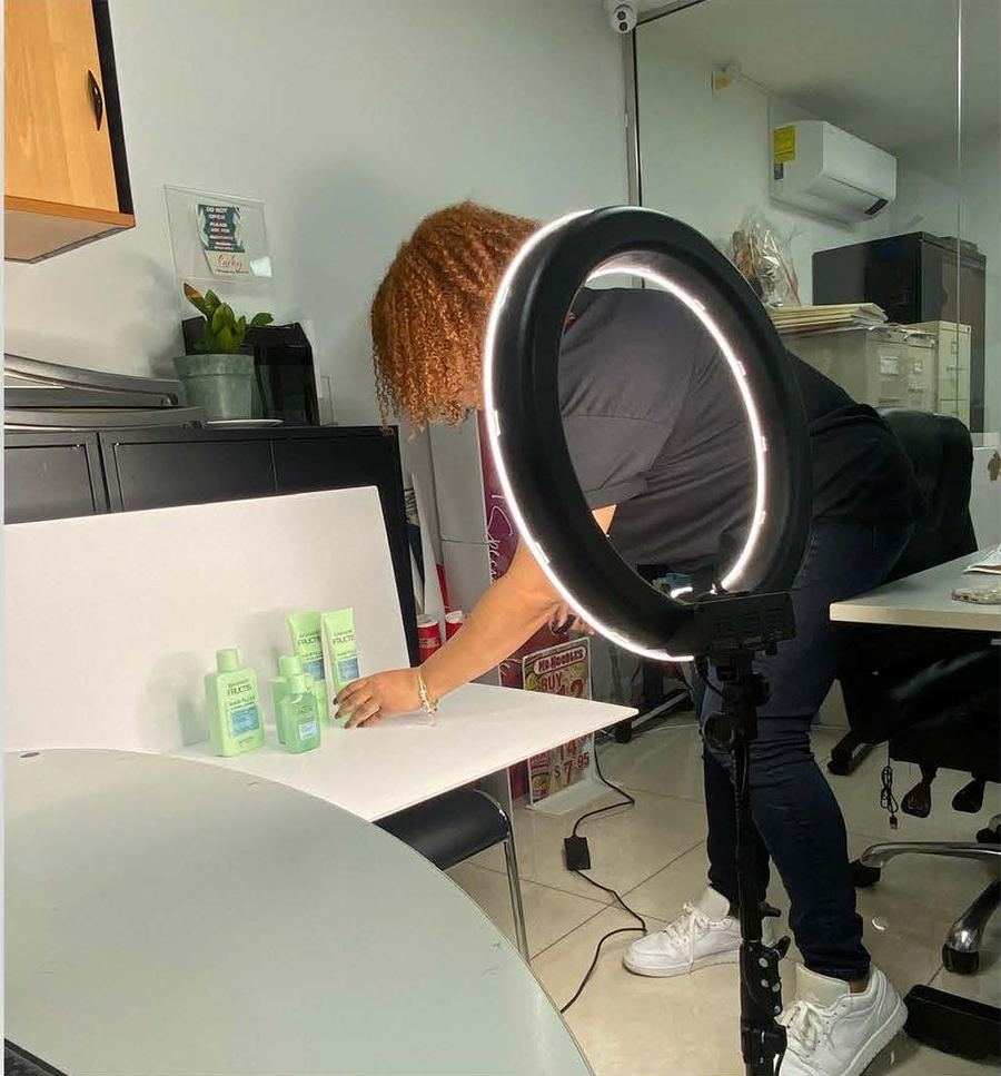 Product photography setup with a ring light and white backdrop
